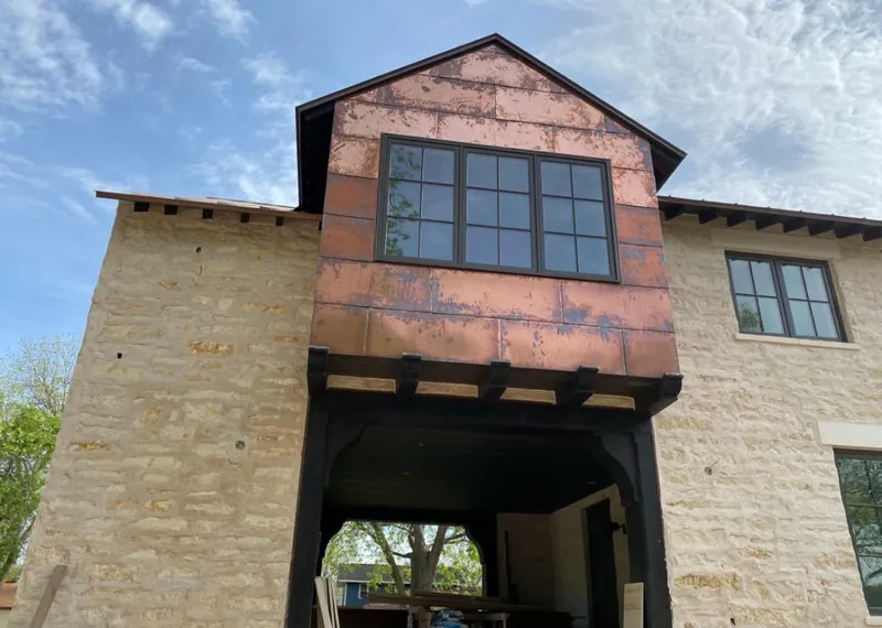 Copper metal panel facade on a stone building for Skylight Installation in Seguin