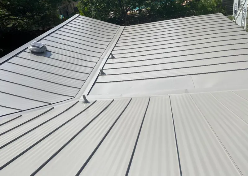 Solar attic fan installed on a metal roof for Roof Ventilation in Seguin